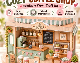 May include: A printable paper craft kit for a miniature coffee shop titled Cozy Coffee Shop. The set includes a green and tan shop structure, a menu board, a display case with donuts, a table with a chair, and coffee-themed accessories.