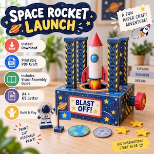 May include: A paper craft space rocket launch set featuring a central rocket on a blue base with four towers, a small astronaut figure, a flag, a globe, a moon disc, and star cutouts. The base displays the text BLAST OFF and the title SPACE ROCKET LAUNCH.