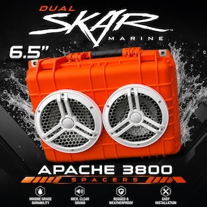 May include: A bright orange Apache 3800 hard case featuring two white 6.5" Dual Skar Marine speakers with a honeycomb grille design. The case has a top handle and is surrounded by a water splash effect. Text includes "DUAL SKAR MARINE", "6.5"", and "APACHE 3800 SPACERS".