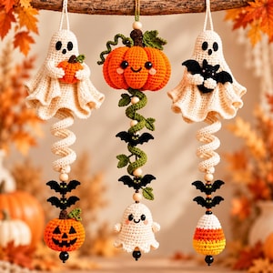 May include: Three hanging crochet ornaments featuring Halloween themes. The left shows a ghost holding a pumpkin, the center a pumpkin with vines and bats, and the right a ghost holding a bat, with dangling pumpkins, bats, and candy corn.