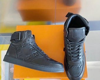 Rivoli Sneaker Boot (High-Top) in Black Monogram-Embossed Grained Calfskin