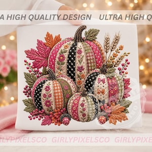 May include: A white square print featuring three pumpkins decorated with patchwork patterns of pink, black, and green floral, polka dot, and plaid designs. The pumpkins are surrounded by autumn leaves, wheat stalks, and berries in vibrant colours.