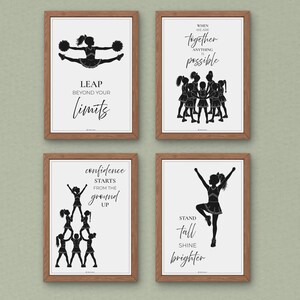 May include: Four framed wall art prints featuring black silhouettes of cheerleaders on white backgrounds. The prints include the text: LEAP BEYOND YOUR LIMITS, WHEN WE ARE TOGETHER ANYTHING IS POSSIBLE, confidence STARTS FROM THE ground UP, and STAND tall SHINE brighter.