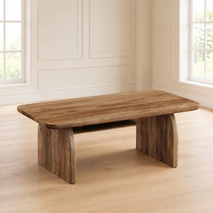 May include: A rectangular coffee table with a natural light brown wood grain finish. The table features a thick, smooth top with rounded corners and is supported by two solid, curved panel legs that extend to the floor on each side.