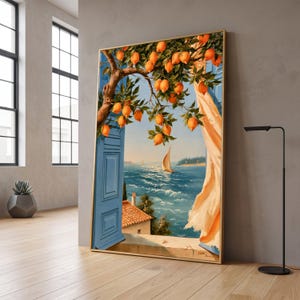 May include: A framed vertical wall art print depicting a Mediterranean coastal scene viewed through an open window. A lemon tree branch with bright yellow fruit hangs over a blue shutter and a flowing peach curtain, overlooking a sea with a sailboat.