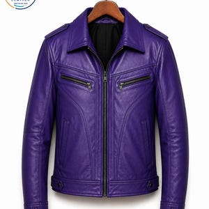 May include: A vibrant purple leather jacket featuring a classic collar, a central front zipper, two horizontal zippered chest pockets, and two vertical side pockets. The jacket includes shoulder epaulets and buttoned cuffs, with a black interior lining.