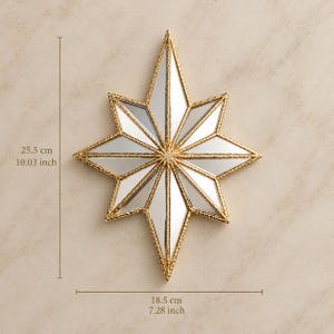 May include: A star-shaped wall mirror with a gold-toned textured frame and multiple mirrored facets. The mirror measures 10.03 inches in height and 7.28 inches in width, featuring a geometric design with pointed rays extending from the center.