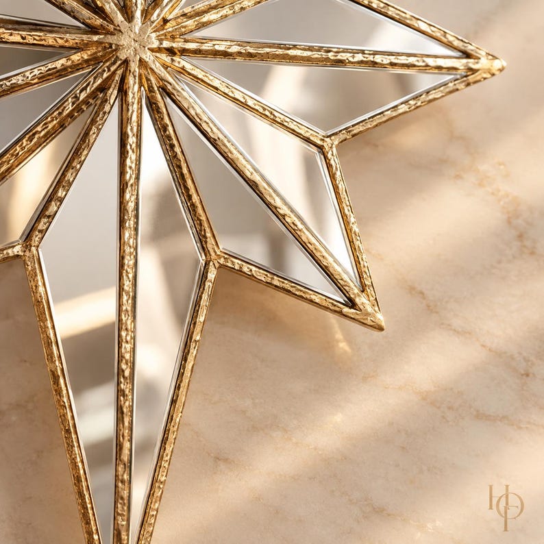 May include: A multi-pointed star-shaped decorative object featuring a textured gold metal frame and mirrored glass panels. The design consists of sharp, elongated points radiating from a central point, creating a geometric star silhouette.