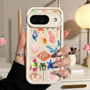 May include: A cream-colored smartphone case featuring a colorful pattern of watercolor-style illustrations including a whale, crab, starfish, seashells, palm tree, hibiscus flowers, and an ice cream cone with a central Summer Beach Party logo.