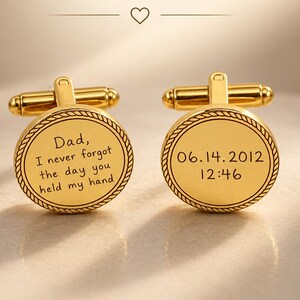May include: A pair of gold-toned circular cufflinks with a rope-style border. One cufflink is engraved with the text: Dad, I never forgot the day you held my hand. The other cufflink is engraved with the date 06.14.2012 and the time 12:46.