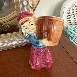 Vintage Ceramic Boy Planter Holding Wooden Bucket, Hand Painted Child Figurine Flower Vase, Red Pants Blue Shirt, Mid Century Kitsch Decor