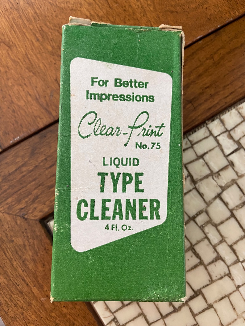 May include: A green box with white text that reads "For Better Impressions Clear-Print No. 75 LIQUID TYPE CLEANER 4 Fl. Oz."