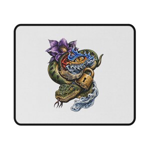 May include: A rectangular mouse pad with a white background featuring a detailed illustration of a green snake coiled around a gold padlock and a purple flower. The design includes a stylized eye surrounded by blue flames and swirling water elements.