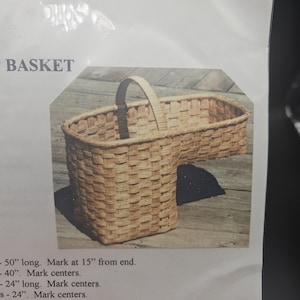May include: A woven light brown basket with a unique L-shaped design and a single arched handle. The text BASKET is visible above the image, and instructions including 50 inches long, mark at 15 inches from end, 40 inches, 24 inches are printed below.