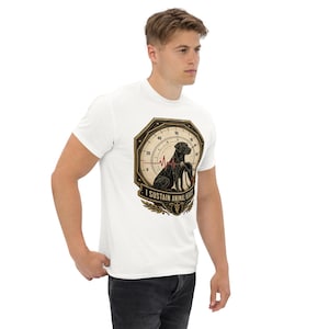 May include: A white short-sleeved t-shirt featuring a graphic of a black dog sitting inside a circular gauge design. A red heartbeat line crosses the gauge. The text I SUSTAIN ANIMAL HEARTS is printed below the dog, accompanied by a small emblem.