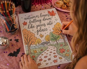 May include: A colouring page featuring a park scene with trees, a bridge, and fallen leaves, with the text "autumn leaves falling down like pieces into place" written in cursive script at the top, coloured with pencils in shades of orange, yellow, and green.