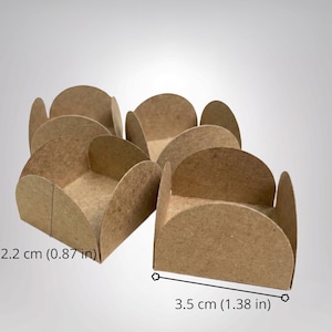 May include: A set of four brown paper candy cups with scalloped edges. Each cup measures 2.2 cm (0.87 inches) in height and 3.5 cm (1.38 inches) in width. The cups feature a simple, open-top design with four rounded sides for holding small treats.