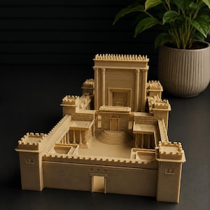 May include: A beige, monochromatic scale model of an ancient temple complex featuring a central sanctuary, surrounding courtyards, colonnaded walkways, and fortified outer walls with crenelated towers at each corner, all rendered in a matte finish.