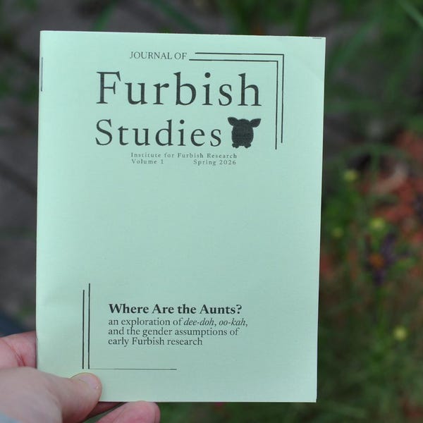 May include: A light green booklet titled Journal of Furbish Studies, Institute for Furbish Research, Volume 3, Spring 2026. The cover features a small silhouette of a creature and the text Where Are the Aunts? an exploration of dee-doh, oo-kah.