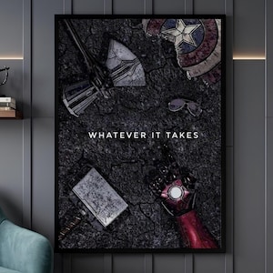 May include: A framed wall art print featuring a dark, cracked ground background with the text "WHATEVER IT TAKES" in white. The image displays a metallic axe, a circular shield, a pair of sunglasses, a rectangular hammer, and a red robotic gauntlet.