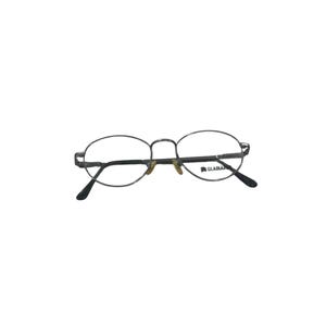 May include: Oval-shaped eyeglasses with a thin, dark metallic frame. The lenses are clear, and the right lens features the word GLADIATOR printed in black. The temples have black plastic tips, and the bridge includes adjustable nose pads.