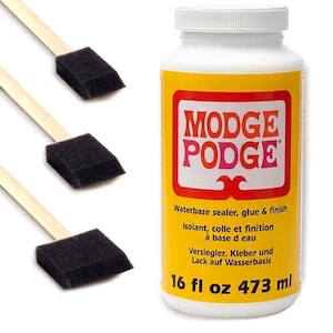 May include: A white plastic bottle of Modge Podge waterbase sealer, glue, and finish with a yellow label, accompanied by three foam brushes featuring black rectangular foam heads attached to light-coloured wooden handles for craft applications.