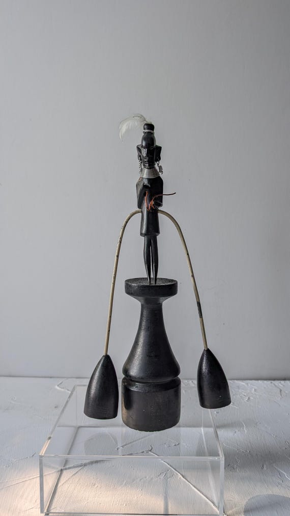 A genuine hand-carved Kenyan Kamba balancing figure — a rare piece of traditional African kinetic folk art where weighted limbs naturally find equilibrium, with real cultural provenance.