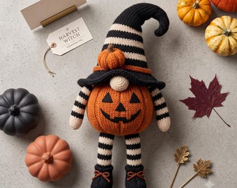 May include: A knitted gnome figure with a pumpkin-shaped body featuring a jack-o'-lantern face, wearing a black and white striped hat with a small pumpkin accent. The gnome has striped arms and legs, black shoes with orange laces, and a tag reading HARVEST WITCH.