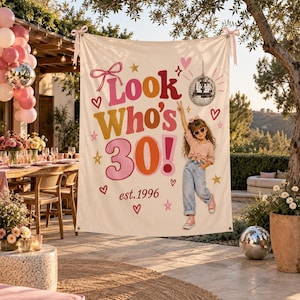 May include: A rectangular cream-coloured fabric banner featuring the text Look Who's 30! est. 1996 in pink, orange, and gold. The design includes a disco ball, stars, hearts, a pink bow, and a graphic of a person wearing sunglasses and jeans.