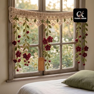 May include: A cream-colored crochet valance featuring hanging vines with green leaves and deep red flowers. The valance has a decorative scalloped edge and a small brown tag that reads "CROCHETED WITH LOVE". A black logo square reads "CK CrochetbyKamals".