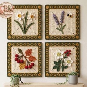 May include: Four square crochet wall hangings featuring cream-coloured centres with dark green borders. The designs include white daffodils, purple lavender with a small bee, orange and brown autumn leaves with red berries, and white flowers with red berries.