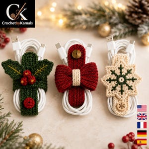 May include: Three crocheted cable organizers wrapped around white charging cords. The left one is dark green with holly leaves and red berries. The center one is red with a bow and gold button. The right one is cream with a green snowflake.