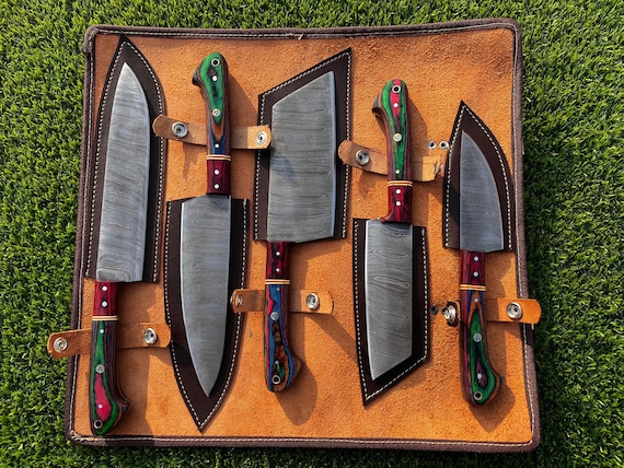 Hand-forged Damascus steel chef set with the swirling layered-metal patterns that make every knife look like wearable art — a real blacksmith made this.