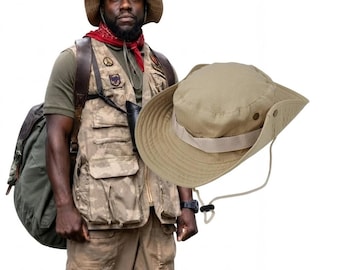 May include: A tan wide-brimmed bucket hat with a matching adjustable chin strap and a side snap button. The hat features a structured crown and a wide brim, designed with a neutral beige fabric finish and a simple, functional aesthetic.