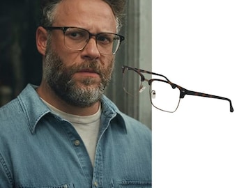 May include: A pair of spectacles featuring a brown tortoiseshell browline frame with thin gold metal rims and temples. The glasses have clear lenses, adjustable nose pads, and a classic rectangular shape with a distinct bridge and temple design.