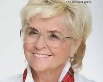 May include: A book cover titled Angie McCartney My Long and Winding Road The first 82.9 years featuring a portrait of a smiling person with blonde hair and glasses wearing a white collared shirt and a red plaid neck scarf with a foreword by Cynthia Lennon.