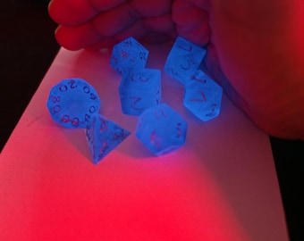 Blaue, im Dunkeln leuchtende Würfel mit silbernen Zahlen