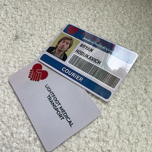 May include: Two rectangular identification cards featuring a red heart-shaped logo with hands. One card displays a photograph of a person, the name BRYAN HODUKAVICH, a barcode, and the text Medical Handler License and COURIER. The other card reads LIGHTFOOT MEDICAL TRANSPORT.