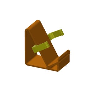 May include: A brown L-shaped stand featuring two light green clips attached to the angled surface. The stand has a solid base and a raised front edge designed to support an object at an incline, with a hollow triangular cutout in the side profile.