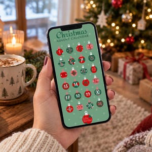 May include: A smartphone screen displaying a digital Christmas Advent Calendar with a sage green background. The design features twenty-four numbered ornaments in red and dark green, with the text Christmas Advent Calendar at the top.