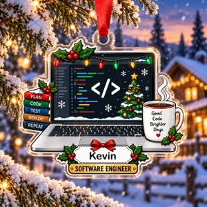 May include: A clear acrylic Christmas ornament featuring a laptop displaying code, a Christmas tree, and the text "</>". A stack of books labeled "PLAN, CODE, TEST, DEPLOY, REPEAT" sits beside a mug with "Good Code Brighter Days" and "Kevin SOFTWARE ENGINEER".