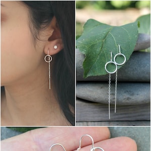 Peut inclure: Boucles d'oreilles pendantes en argent avec un cercle et une barre pendante. Les boucles d'oreilles sont présentées sous plusieurs angles, notamment sur une oreille et dans une main. Design simple et élégant.