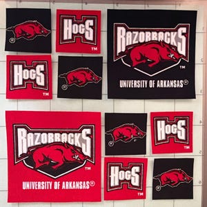 May include: A collection of square fabric patches featuring the University of Arkansas Razorbacks logo. The designs include red hog silhouettes on black backgrounds, white HOGS text on red backgrounds, and large Razorbacks logos on black or red.