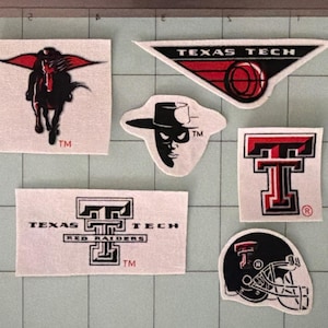 May include: A collection of six Texas Tech University fabric patches featuring the Masked Rider, a triangular logo with a basketball, the Raider Red mascot face, a block T logo, a Texas Tech Red Raiders wordmark, and a football helmet graphic.