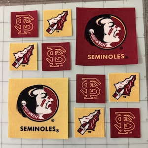 May include: A collection of fabric patches featuring Florida State University logos. The set includes square patches in garnet and gold, displaying the Seminoles mascot head, the interlocking FS logo, and a spearhead graphic with the text SEMINOLES.