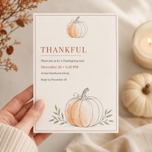 May include: A rectangular invitation card featuring a watercolor pumpkin illustration at the top and bottom, with the text THANKFUL, Please join us for a Thanksgiving meal, November 26, 6:30 PM, At the Hawthorne Home, and Reply by November 18.