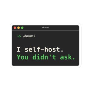 May include: A rectangular sticker featuring a dark gray computer terminal window with red, yellow, and green buttons at the top. The text reads "whoami" in the title bar, "~$ whoami" on the first line, and "I self-host. You didn't ask." below.