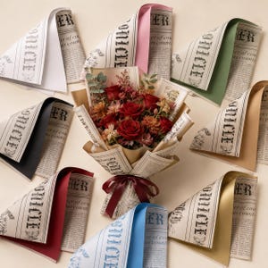 May include: A central bouquet of deep red roses and assorted dried flowers wrapped in vintage-style newspaper print paper with a dark red ribbon, surrounded by eight individual sheets of newspaper-style wrapping paper in various colours.