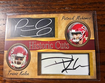 May include: A rectangular sports trading card titled Historic Cuts featuring two autographs and two circular portraits. The top features Patrick Mahomes' signature and photo in a red helmet. The bottom features Travis Kelce's signature and photo in a red helmet.