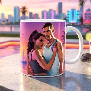 May include: A white ceramic mug featuring a colourful graphic illustration of a woman and a man standing together against a sunset city skyline. The woman wears a dark top, and the man wears a light tank top while holding a small handgun.